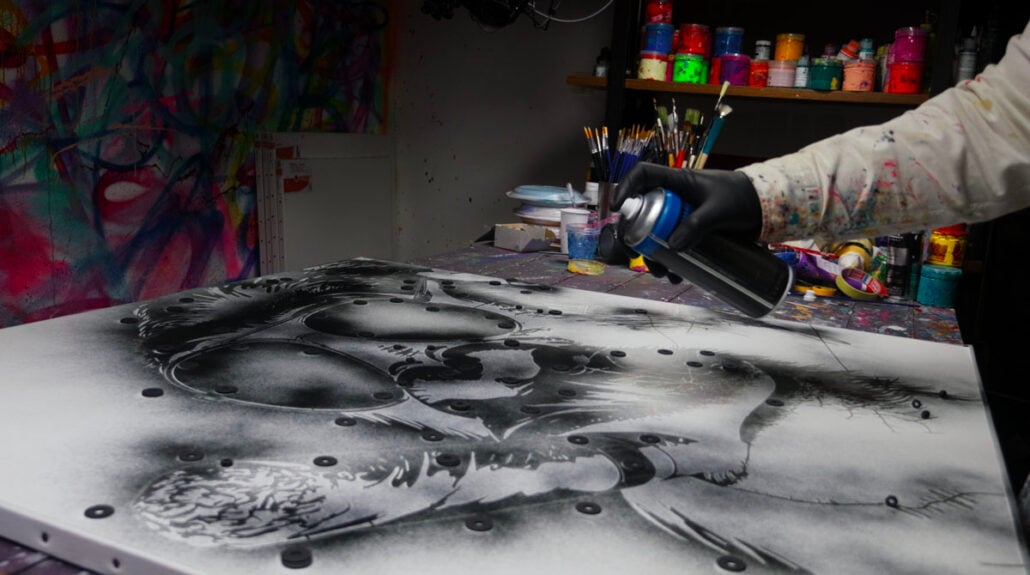 Applying the stencil with black spray paint to reveal the gorilla's silhouette - Step 1 The Don