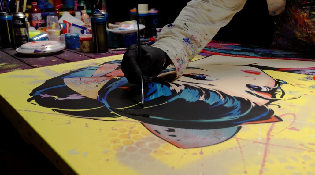 Using black paint and a fine brush to manually fill stencil gaps and unify the figure's outline